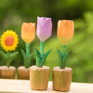 Handcrafted wooden tulip and sunflower flower ornaments close-up detail view on desk