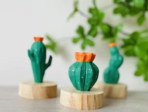 Handcrafted wooden cactus figurine detail shot, natural solid wood base, green and orange decor
