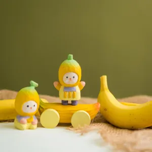 Handcrafted wooden banana figurine detail with intricate carving and bright hand-painted finish.