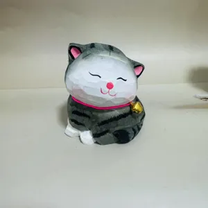 Handmade carved wooden cat figurine with cute bell and stripes, perfect room decor detail.