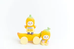 Wooden cartoon banana figurine desktop ornament detail view and mini wheeled cart.