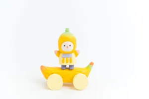 Hand-carved wooden banana figurine detail view, cute creative desktop decoration toy piece.