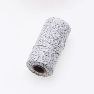 Close up detail of silver threaded white cotton twine roll, perfect for gift wrapping string.