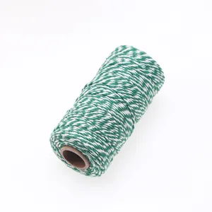 Detail shot of green and white twisted cotton twine roll, perfect for gift wrapping and crafts.