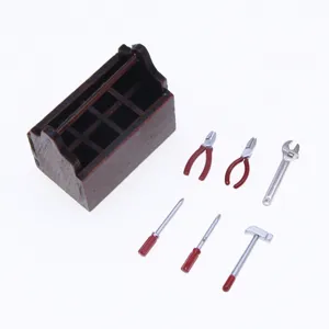 Miniature wooden toolbox detail with tiny metal tools, perfect for dollhouse setup.