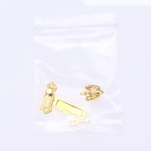 Miniature dollhouse golden metal door lock key hardware set detail view showing exquisite parts.