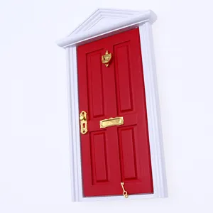 Miniature dollhouse red wooden door model with gold hardware details, close-up shot.