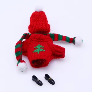 Mini doll knitted sweater detail view, red and green Christmas style clothing with shoes.