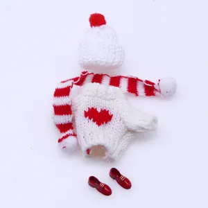 Close-up of miniature doll knitted clothes set, including sweater, scarf, hat and cute shoes.