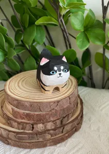Handmade wooden cute animal figurine detail, small desktop ornament, natural wood display.