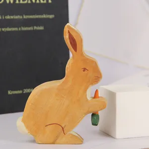 Handmade wooden rabbit figurine holding carrot, cute animal toy desktop decoration for home.