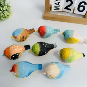 Close-up view of vibrant hand-carved wooden bird figurines, colorful desktop decor display.