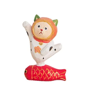 Handcrafted wooden cat figurine desktop ornament, creative lucky cat standing on red fish decor.
