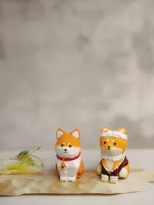 Wooden cartoon dog figurines detail shot, handmade carved craft ornaments for desktop decor.