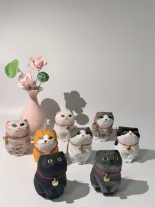 Detailed view of handcrafted geometric wooden cat figurines with cute bells for desktop decor.