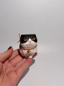 Handcrafted wooden cat figurine detail, cute desktop decoration, healing gift and pet.