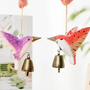 Handmade wooden hummingbird hanging ornament with metal bell for yard and home decor.