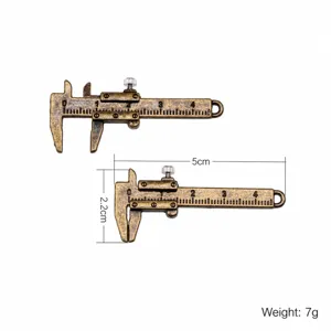 Miniature metal vernier caliper model for dollhouse, movable scale measuring tool.