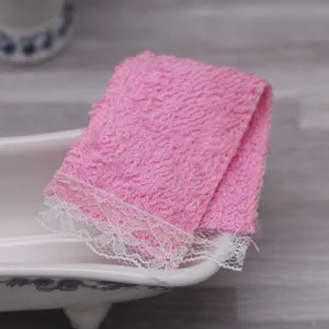 Dollhouse miniature pink towel with white lace trim for bathroom doll furniture decor.