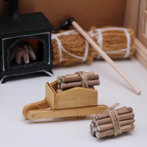 Miniature wooden wheelbarrow with tiny firewood logs for dollhouse winter scene display detail.