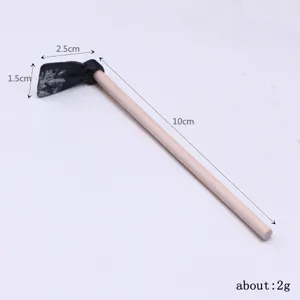 Miniature wooden garden hoe detail view, dollhouse accessory, 10cm length, lightweight toy.
