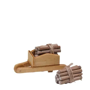 Dollhouse miniature wooden wheelbarrow with firewood logs set for winter scene decor accessory.