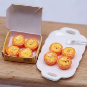 Dollhouse miniature simulated egg tart set with tiny paper box and ceramic tray models.