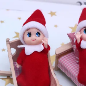 Mini Christmas elf doll with red hat and wooden cradle, perfect for dollhouse and holiday decor.