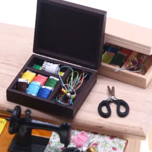 Miniature sewing box dollhouse accessory detail view showcasing vintage mini thread spools