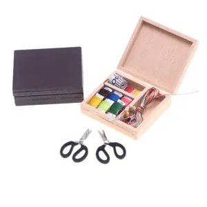 Miniature dollhouse wooden sewing box set with scissors and thread spools for micro scene decor.