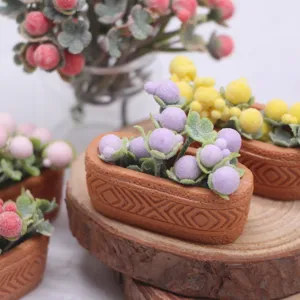 Miniature artificial berry potted plant detail, cute dollhouse micro landscape accessory.
