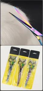 Detailed view of rainbow pet grooming scissors showing hair cutting action and retail packaging.