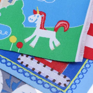 Detailed close-up of miniature dollhouse carpet featuring a cute unicorn woven pattern.