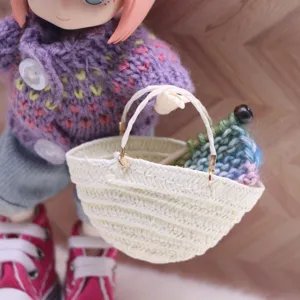 Detailed close-up of a mini woven straw basket for dollhouse, perfect for miniature scenes.
