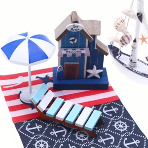 Dollhouse miniature beach house set with wooden cabin, lounge chair, umbrella, and carpet.