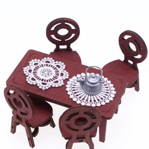 Miniature dollhouse wooden table chairs set with white lace crochet placemats for decor.