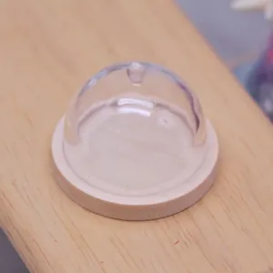 Miniature dollhouse clear plastic cake dome with wood base detail view for doll food play.