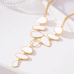 Gold-tone long Y-necklace featuring elegant white enamel oval pendants for elegant evening wear.