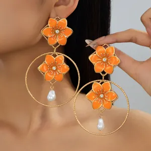 Retro orange flower drop earrings with hollow metal hoops and baroque pearl pendants for women.