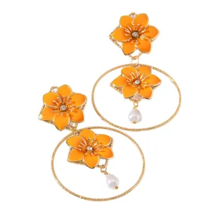 Retro resort style orange flower hollow metal hoop earrings with rhinestones and pearl drops.