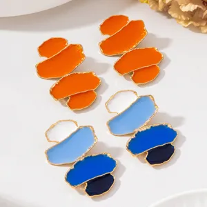 Vue de detail des boucles d'oreilles pendantes blocs de couleur email art moderne chic.