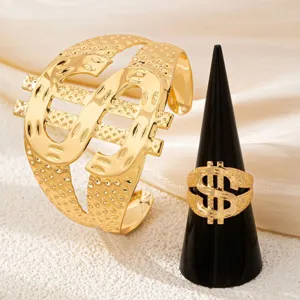 Gold dollar sign ring and bracelet set close-up, hip-hop style metal jewelry detail view.