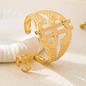 Gold-toned dollar sign shaped metal cuff bracelet and matching open ring jewelry set for women.