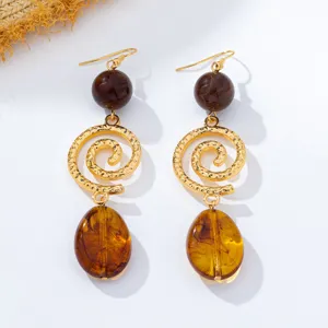 Vintage French style long drop earrings with brown beads, textured gold spiral and amber pendants.