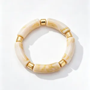 Vintage acrylic bamboo bracelet detail shot, translucent marbled beige segments with metallic gold beads.