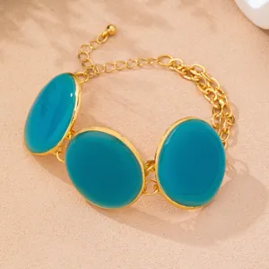Exquisite gold chain bracelet featuring three vibrant blue oval enamel discs for a chic look.