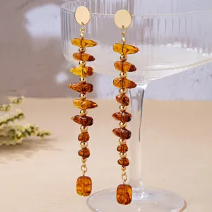 Close-up detail of French vintage style irregular amber beaded long drop earrings.