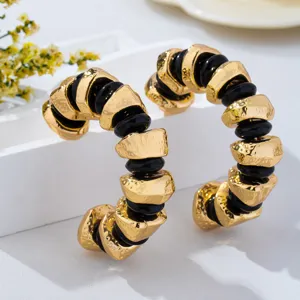 Detailed view of French vintage irregular textured metal and black beaded hoop earrings design.