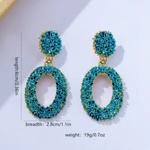 Textured hollow geometric oval earrings with vibrant blue and gold finish for women detail view.