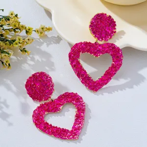 Exaggerated textured hollow heart earrings, bold pink retro statement jewelry for women.